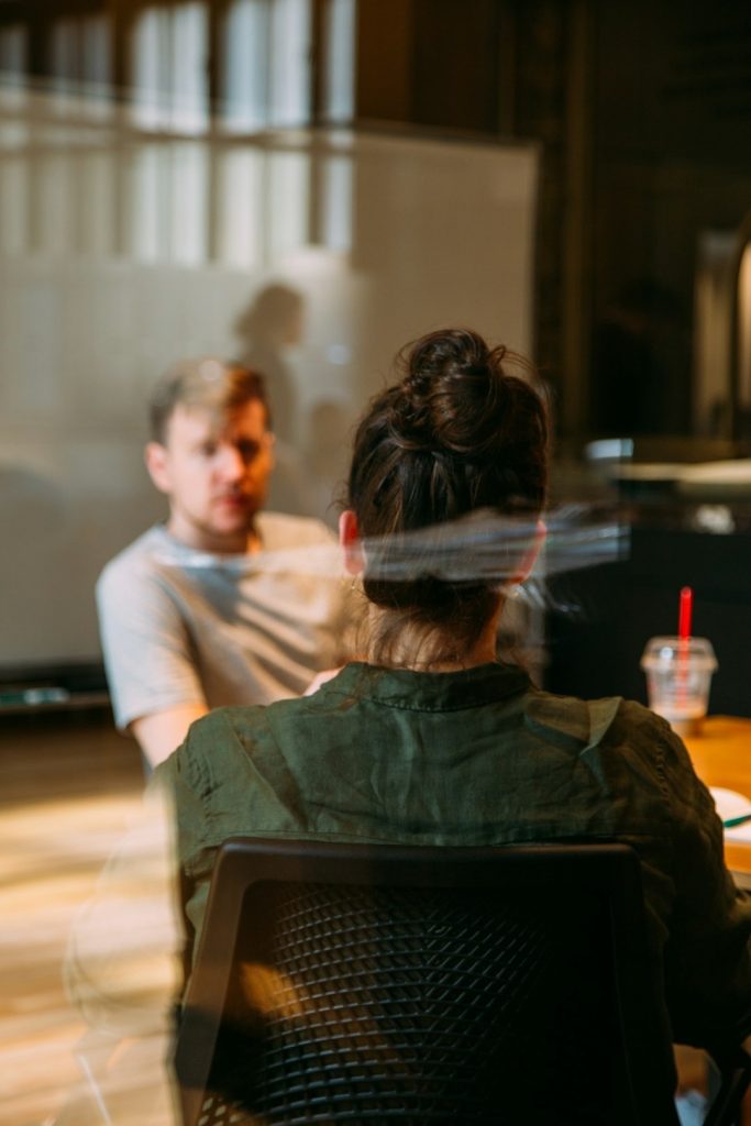 Two people talking through ideas in a 1-2-1 mentoring session